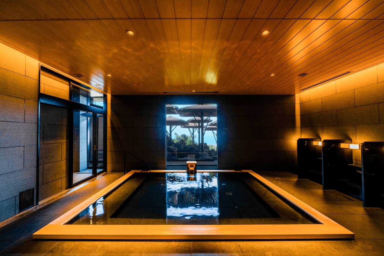 An indoor spa bath with deep golden lighting