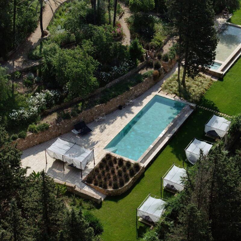 Overhead view of a rectangular swimming pool and gardens
