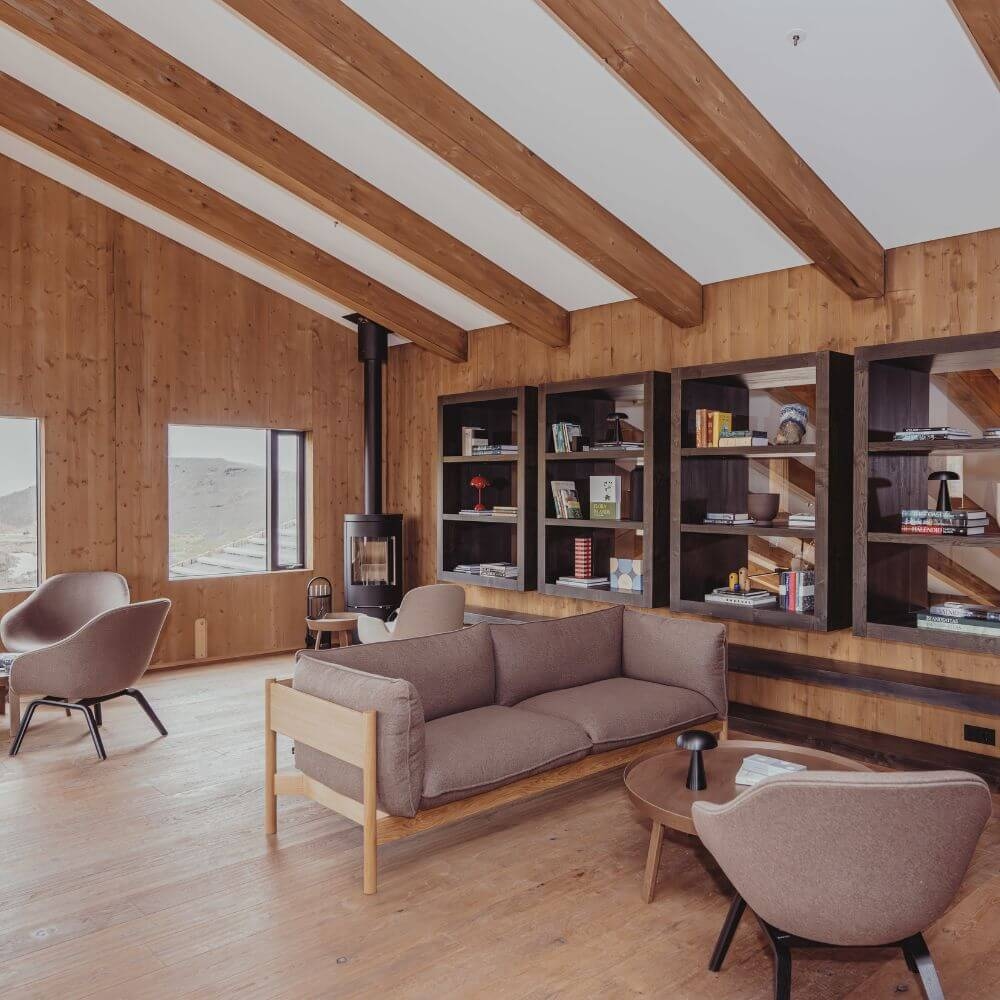 Highland Base hotel lounge with chairs, couch and bookshelves