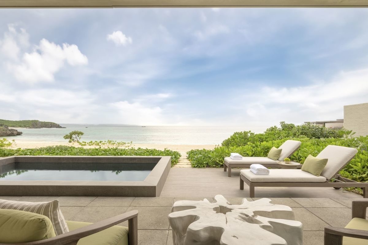 A photo of a private outdoor pool in a villa at Rosewood Miyakojima, with the beach behind it