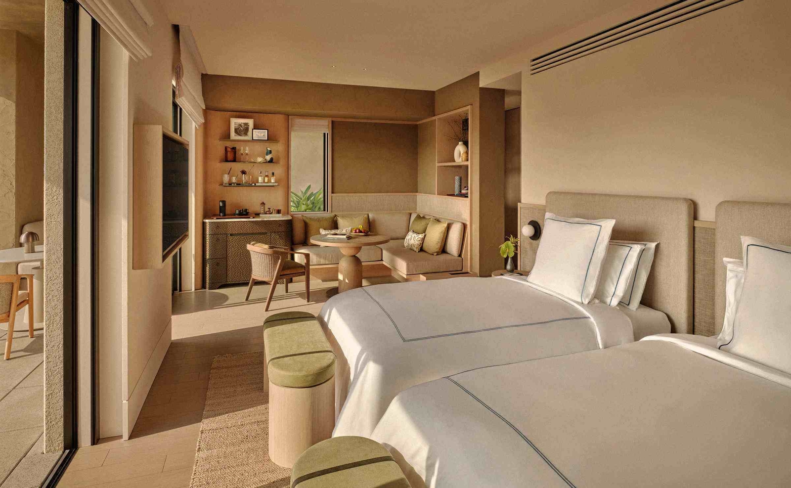 The bedroom and living area in a villa at Rosewood Miyakojima
