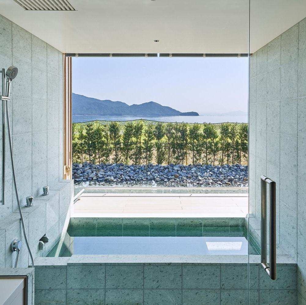 An indoor stone bathtub in a waterfront villa at Simose Art Garden Villa overlooking the scenery
