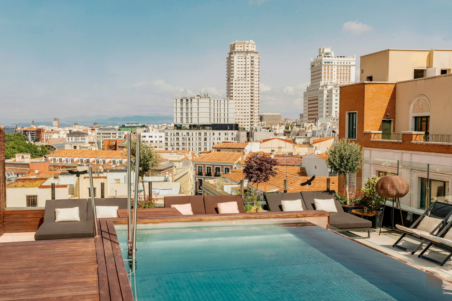 Rooftop pool with a view over the roofs and skyscrapers of Madrid.