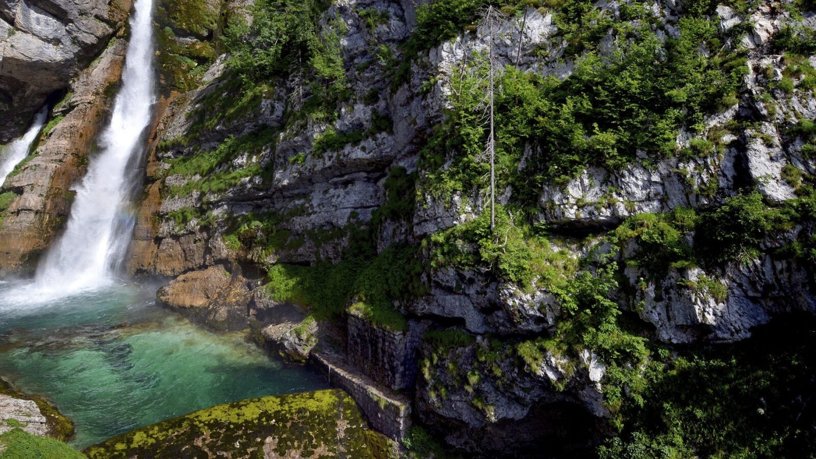Waterfall down a sheer rock face in the alps of Lake Bohinj in Slovenia