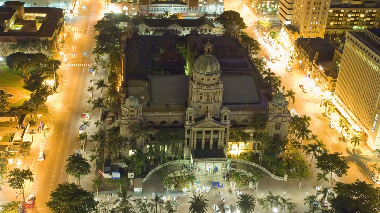 Aerial view of a grand historic building at night during luxury Durban tours.