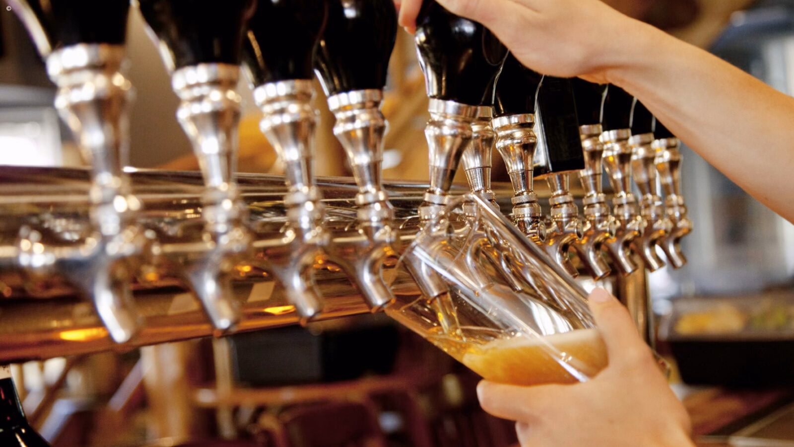 Close up of a woman pouring beer a a bar