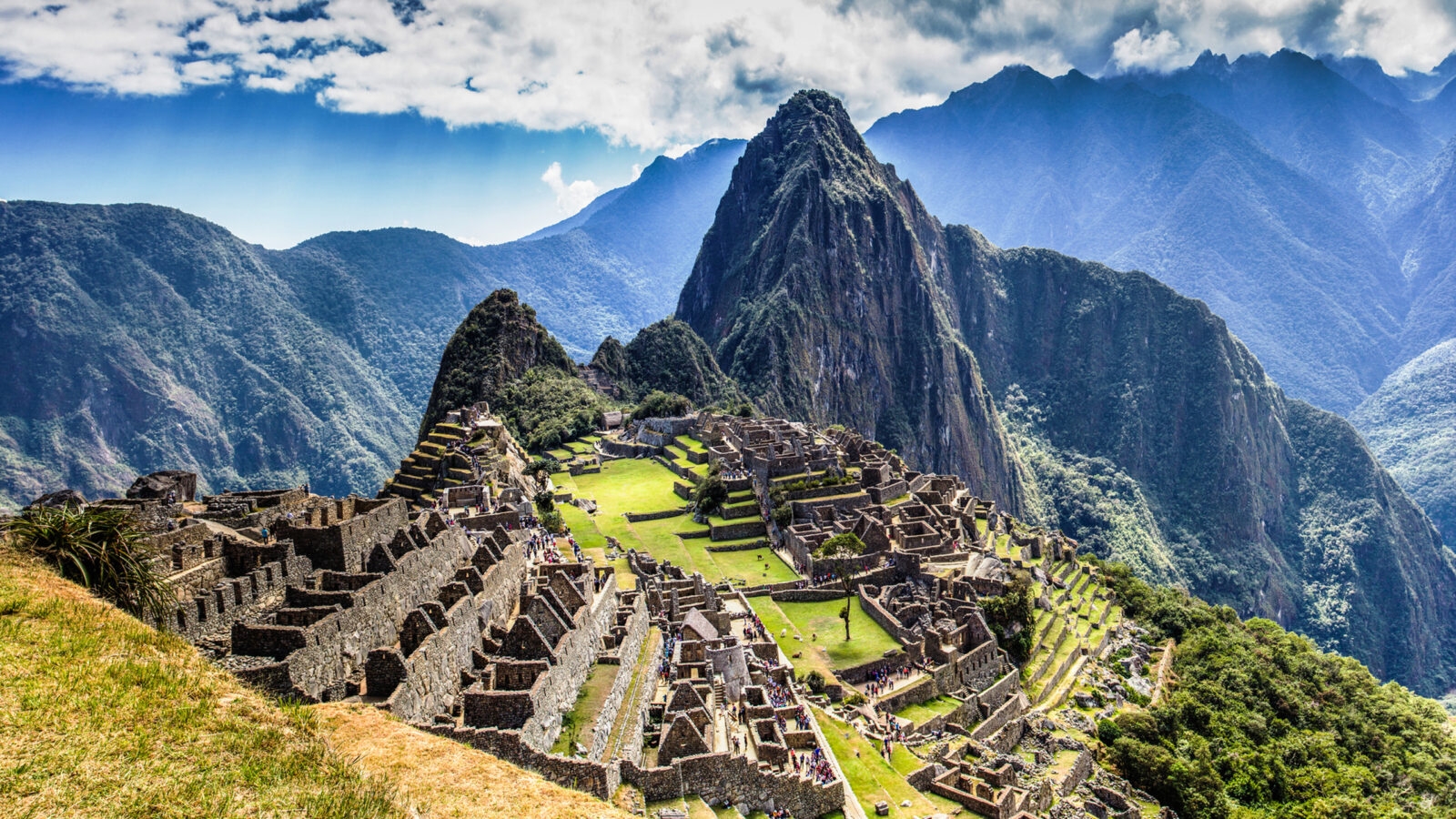 epic expeditions - The ruins of ancient citadel Machu Picchu in the Peruvian mountains on a bright and cloudy day