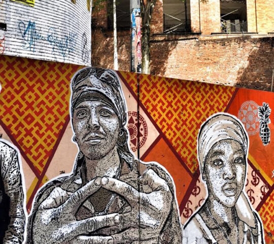 A painted mural in front of a tall building in Colombia