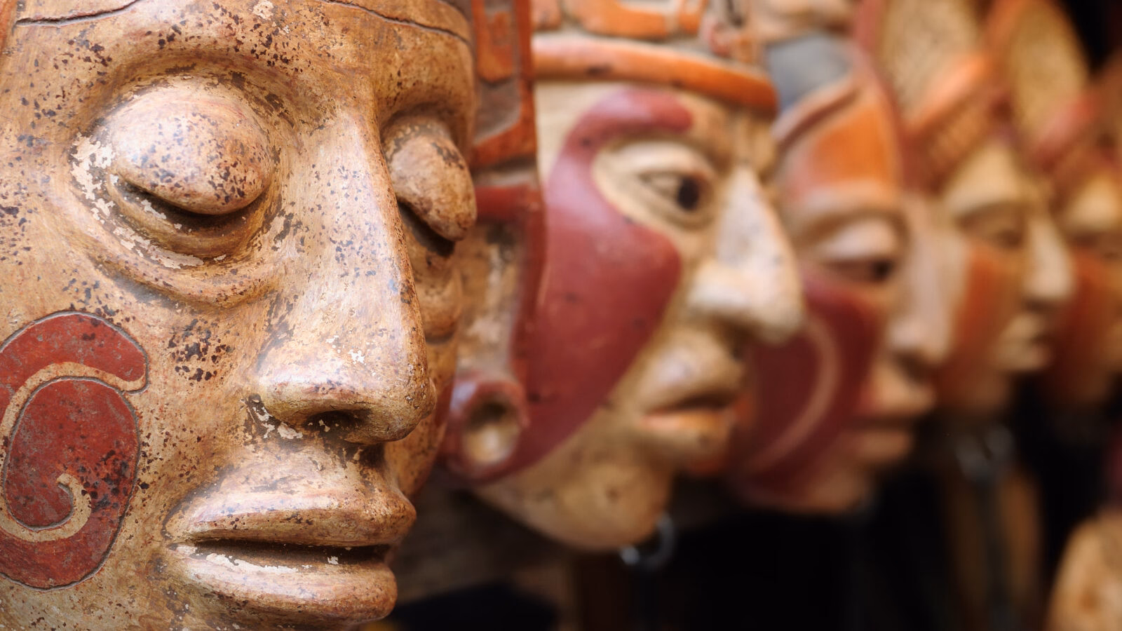 Close up of traditional Mayan clay masks at the Chichicastenango market in Guatemala