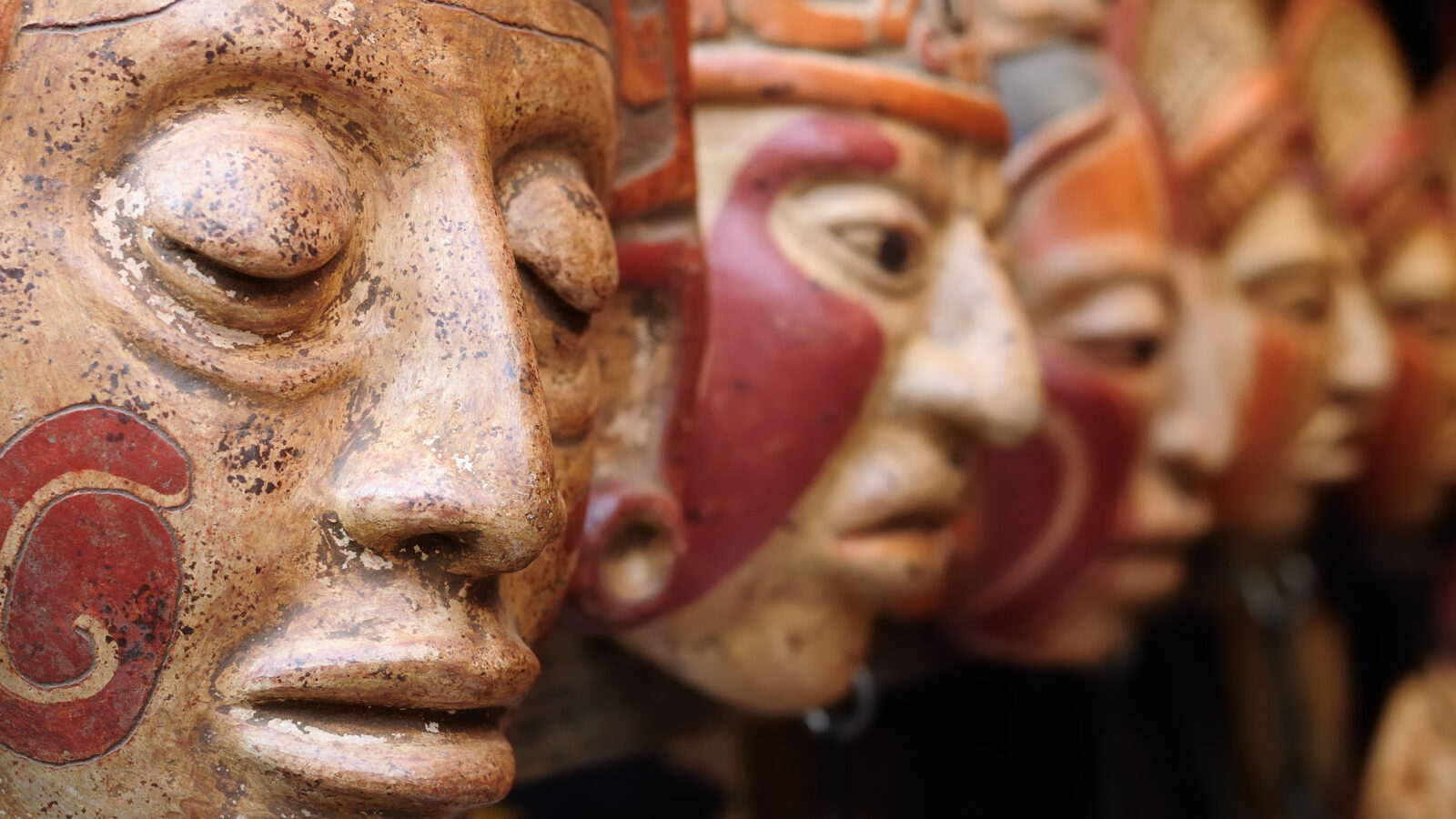 Close up of traditional Mayan clay masks at the Chichicastenango market in Guatemala