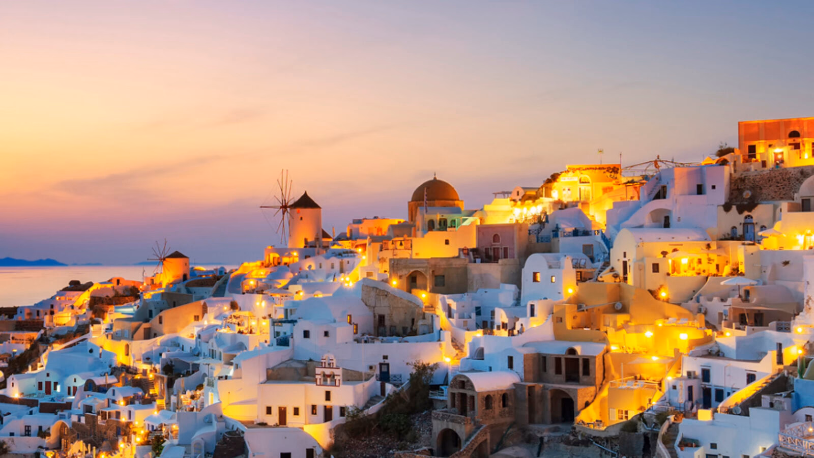 Luxury Grand Tours of Europe - Panoramic view of Oia at sunset