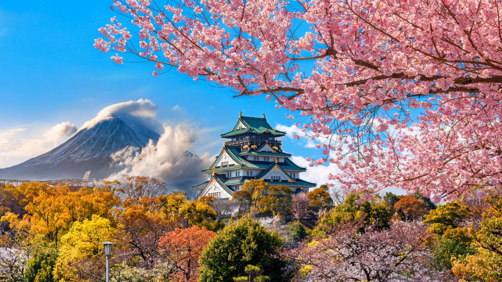 Osaka Castle surrounded by autumn colors and cherry blossoms with Mount Fuji in the background during luxury family vacations to Japan.