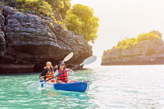 Luxury Thailand Tours - Mother and daughter travel by kayak in blue waters