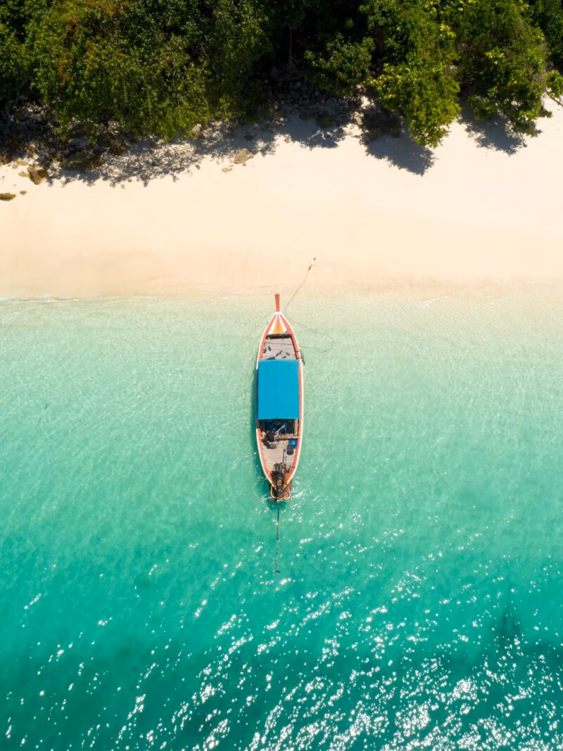 Luxury Thailand Tours - Long tail boat on the beach.Wonderful background.Aerial view from Andaman beach.