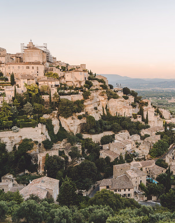 A breathtaking view of a stone hilltop village in Provence during luxury France tours.