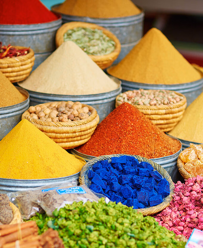 Selection of pyramids of brightly coloured spices on a Moroccan market on a luxury Morocco holiday