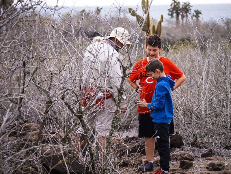 Children and a guide exploring nature on luxury Galapagos family tours.