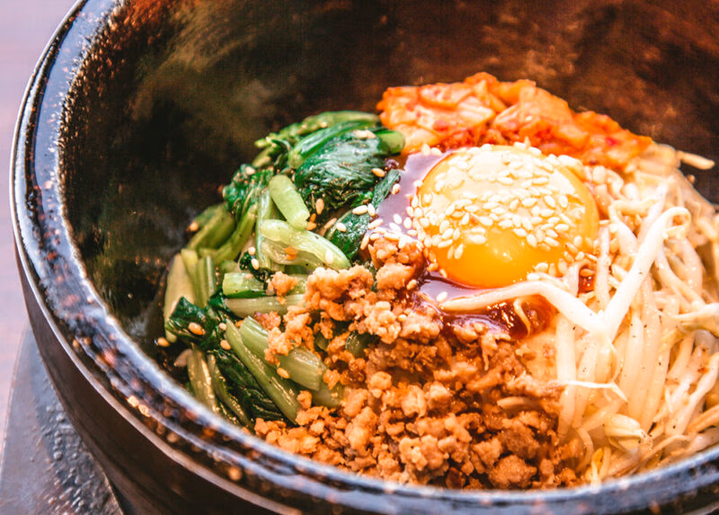 Close-up of a traditional bibimbap bowl served during luxury South Korea holidays.