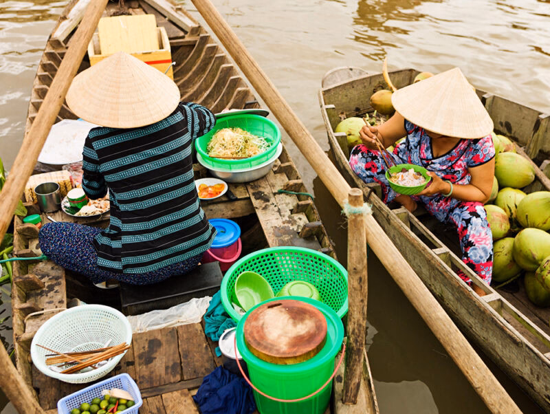 Luxury Vietnam Tours - Vietnamese woman selling Pho - noodle soup on floating market