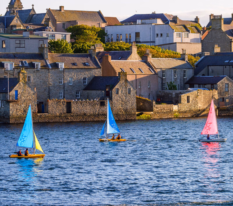 Cityscape in Lerwick with colorful sailboats in the water