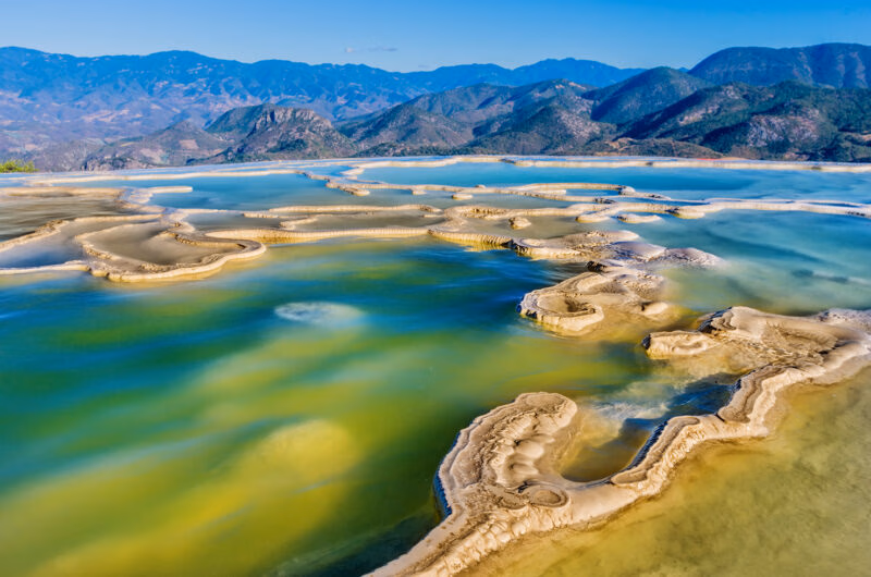Turquoise mineral pools overlooking a mountain valley during luxury Latin America honeymoon holidays.