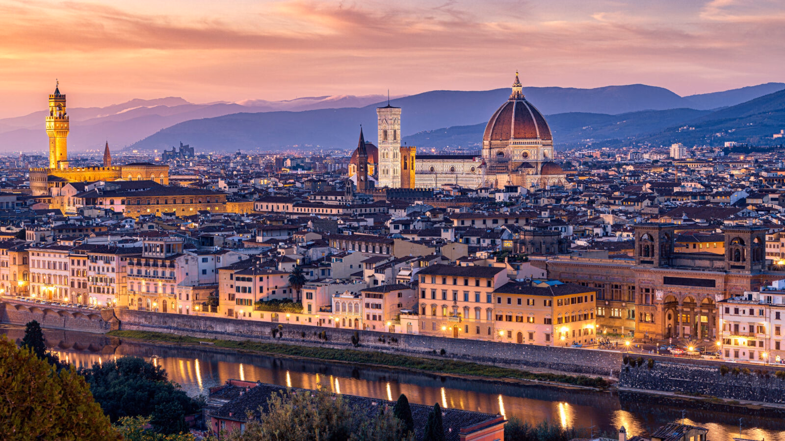 Luxury Grand Tours of Europe - Sunset over the city of Florence - view from hilltop a=outside the city showing the grand dome of the cathedral, city spires and rolling hills in the background
