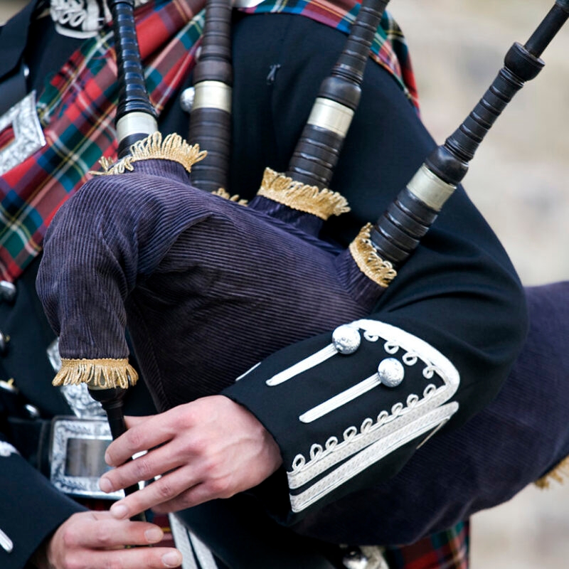 Luxury Grand Tours of Europe - Close-up mid section of a man playing the Scottish bagpipes
