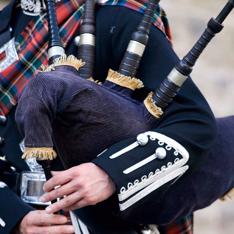 Luxury Grand Tours of Europe - Close-up mid section of a man playing the Scottish bagpipes