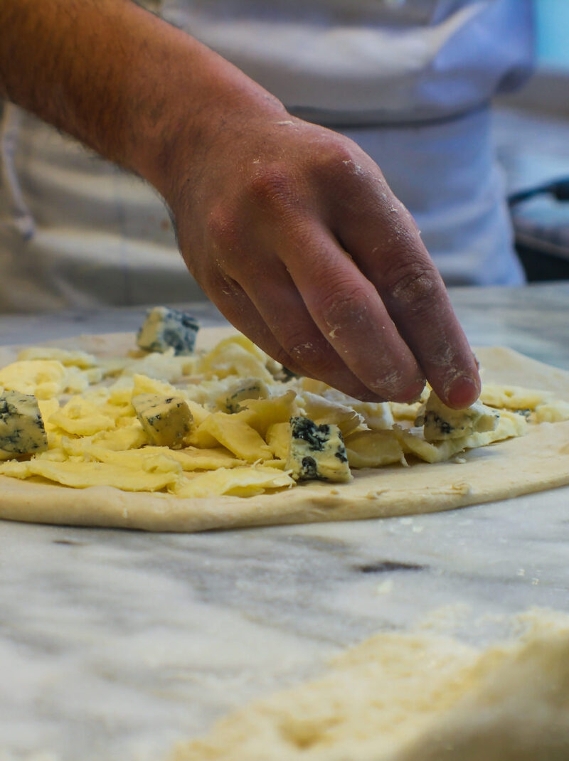 A person making fresh pizza in Rome.