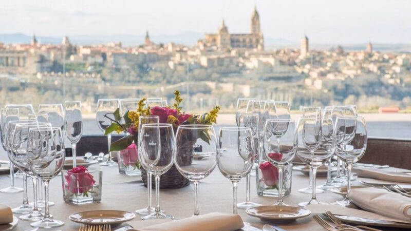 Elegant table setting with wine glasses and flowers for luxury special occasion trips.