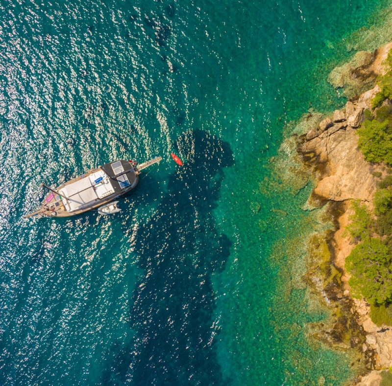 An aerial view of a gulet (two-masted or three-masted wooden sailing vessel) from the southwestern coast of Turkey.