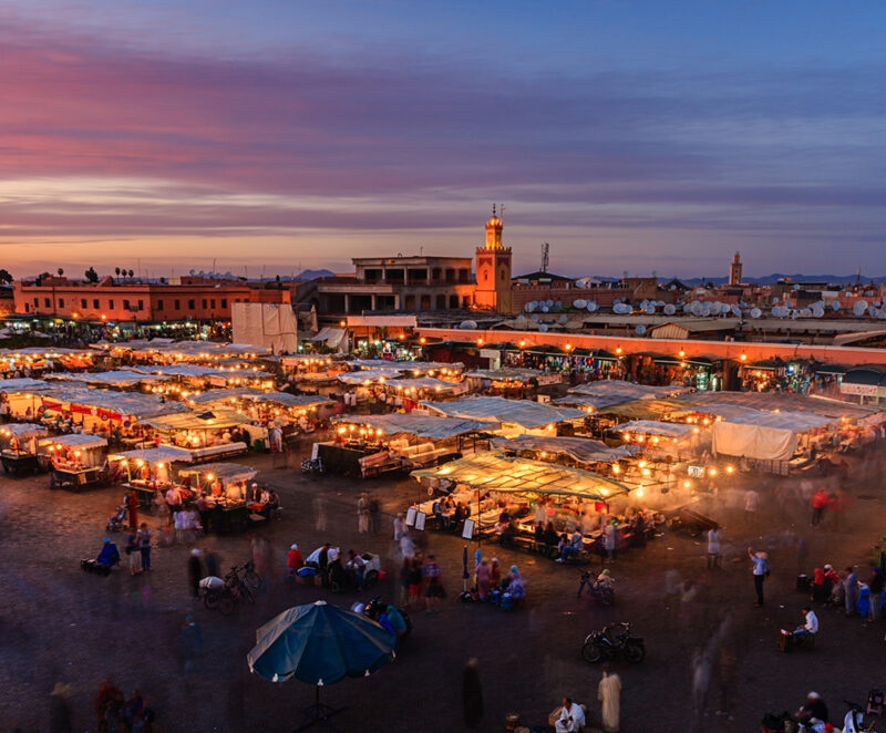 Marrakech outdoor souk with tented stalls at sunset