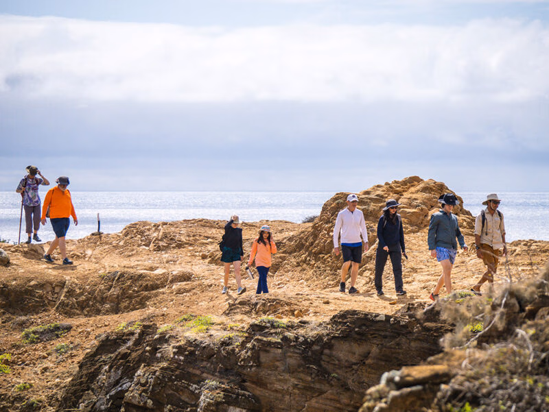 people hiking at the coast while on a luxury latin America vacation