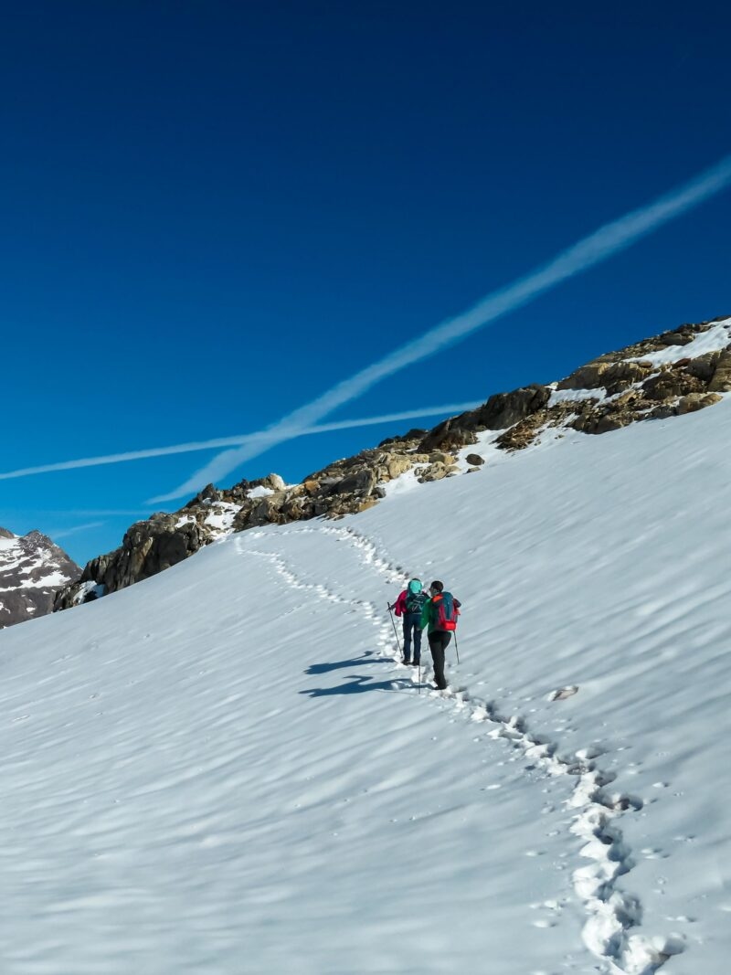 Couple on ski tour next to glacier lakes with scenic view on Hoher Sonnblick in High Tauern mountains in Carinthia