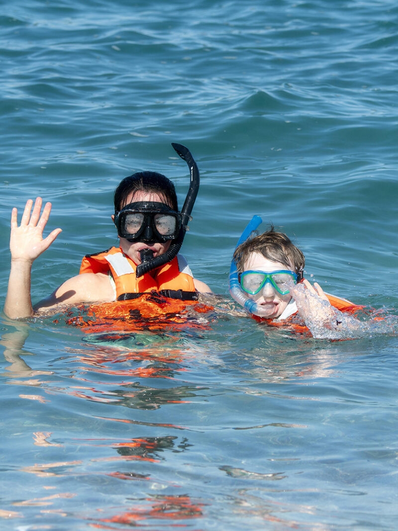 Mother and Young Son Snorkeling with Life Jackets in the Ocean at Punta Mita