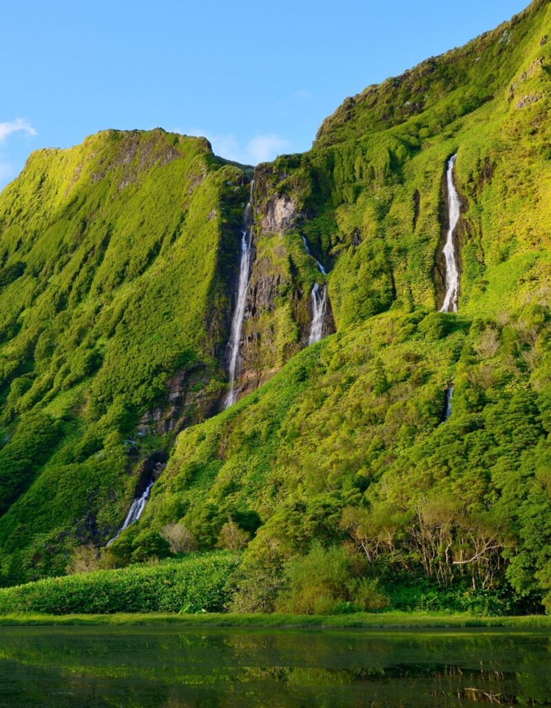The lush cliffs and waterfalls of Poço da Alagoinha on Flores Island in the Azores