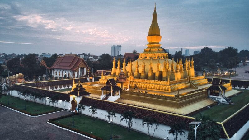 The massive gold-covered Pha That Luang stupa in Vientiane, a landmark for luxury Laos holidays.
