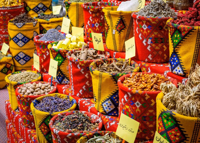 Colorful bags of spices and herbs at a local market visited on luxury Oman tours.