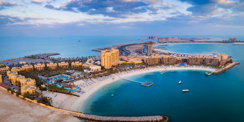 Aerial view of a coastal beach resort and turquoise water for luxury United Arab Emirates tours.
