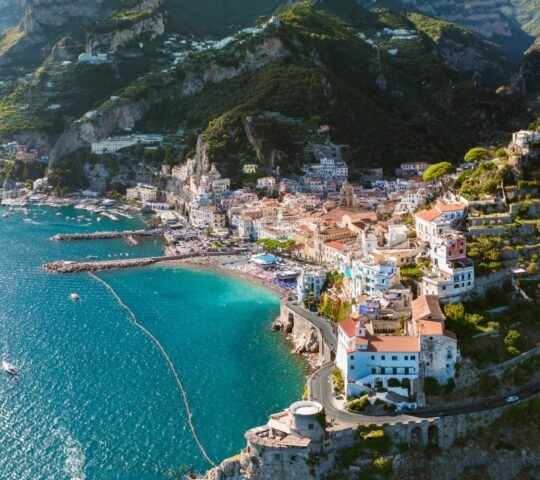 Amalfi Coast from above in summer, showing the gorgeous blue water against the cluster of brightly coloured buildings