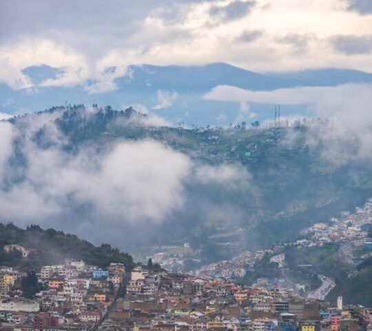 A cloudy view of Quito in Ecuador, taken from atop a hill.