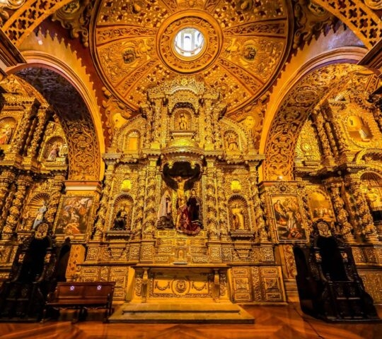 The interior of an orange-hued church