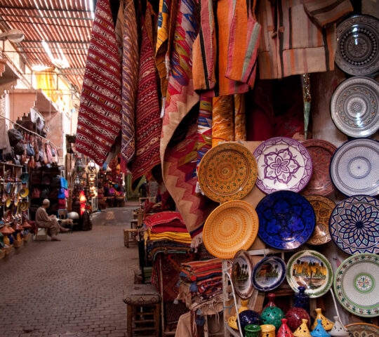 A souk in Marrakesh selling plates and fabric