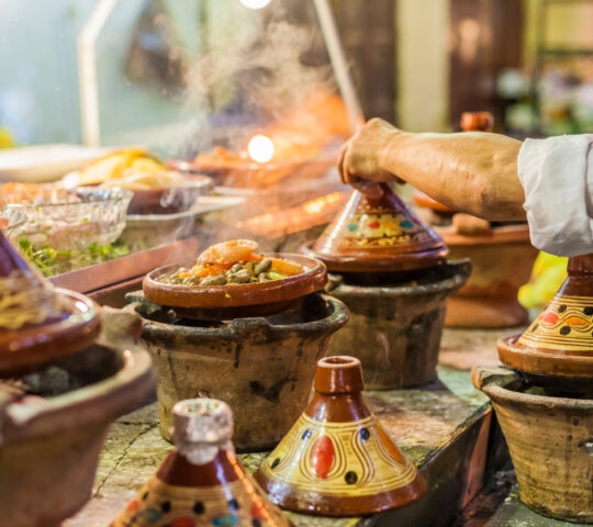 Colourful, traditional Moroccan tajines (casserole dishes) containing food