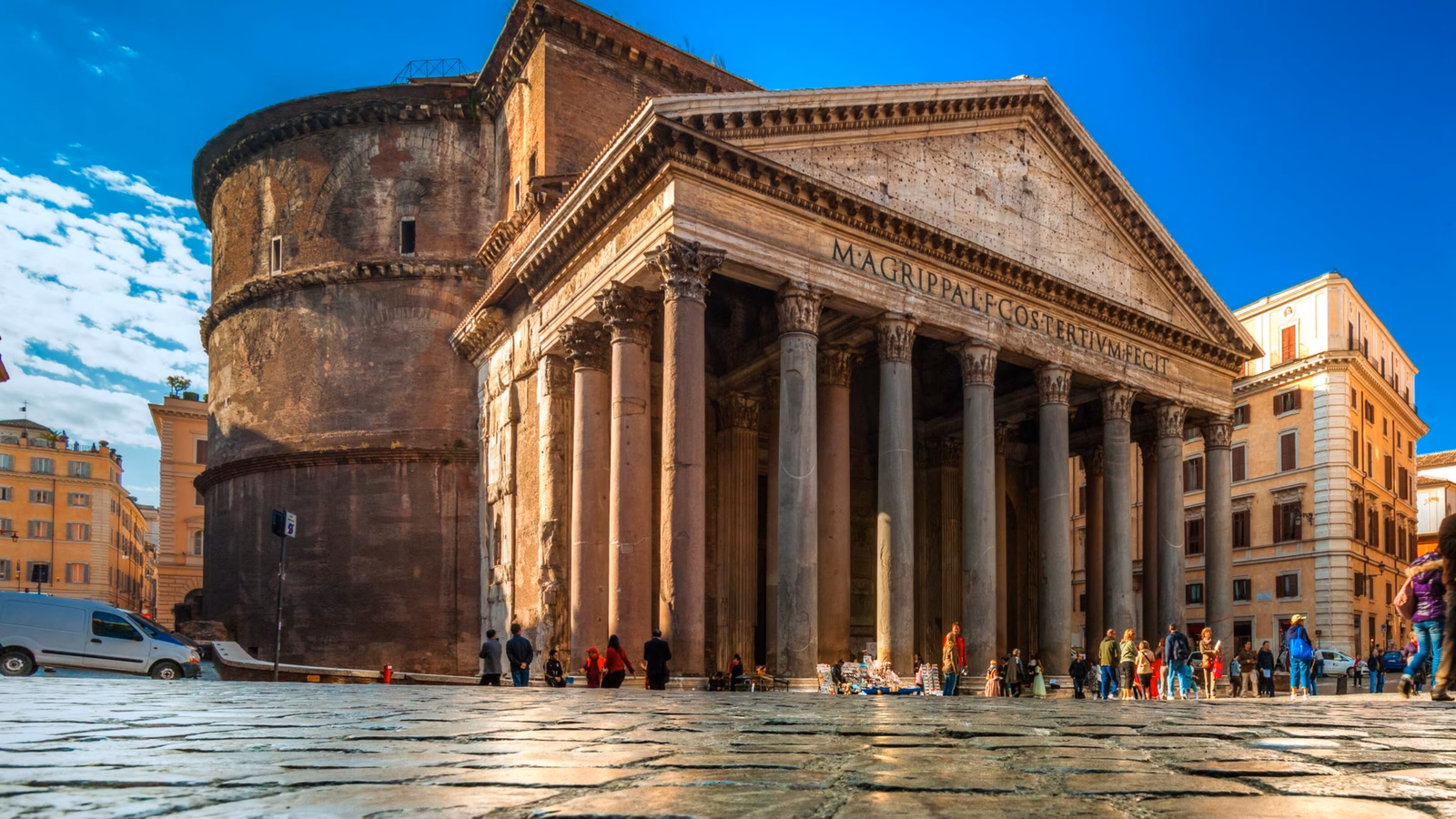 Wide shot of the Roman Pantheon showing its portico with large pillars and the attached ancient brick rotunda.