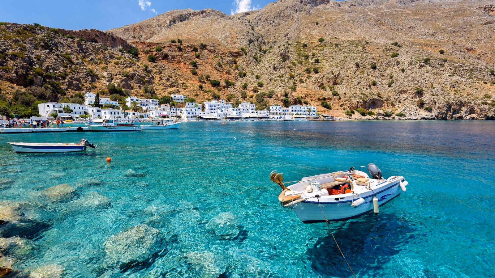 Motorboat at clear water of Loutro town on Crete island