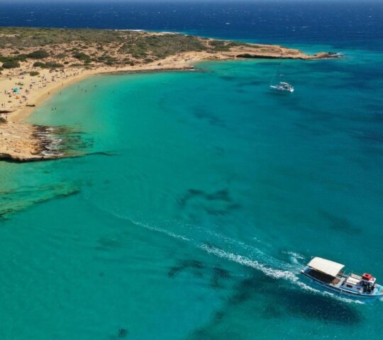 Aerial drone photo of iconic breathtaking turquoise sandy beach of Platia Pounta or Italida in famous island of Koufonissi, Small Cyclades, Greece