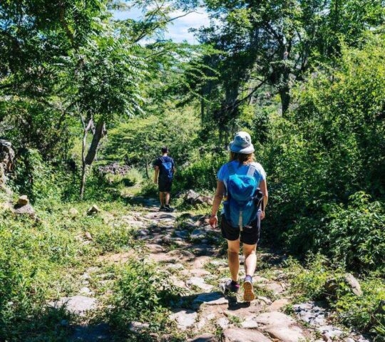 Two hikers on the ancient stone paved road from Barichara to Guane called "El Camino Real". , Barichara/ Colombia/ South America