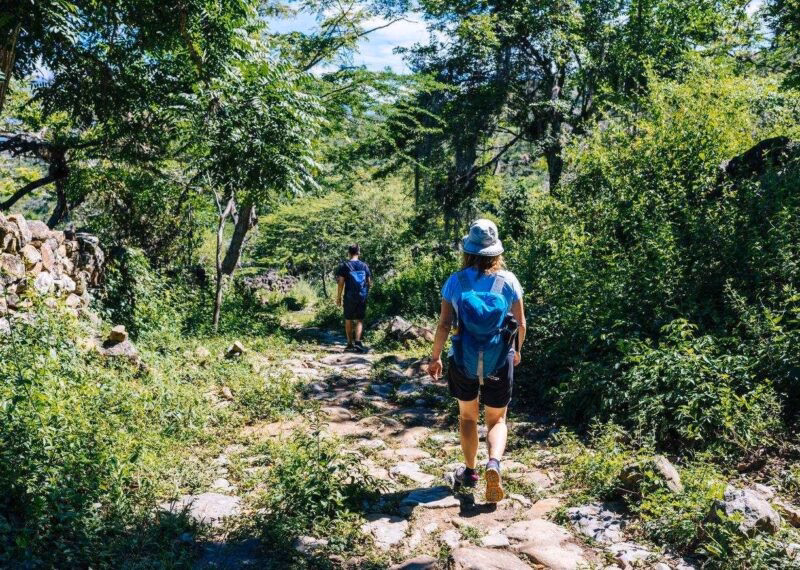 Two hikers on the ancient stone paved road from Barichara to Guane called "El Camino Real". , Barichara/ Colombia/ South America