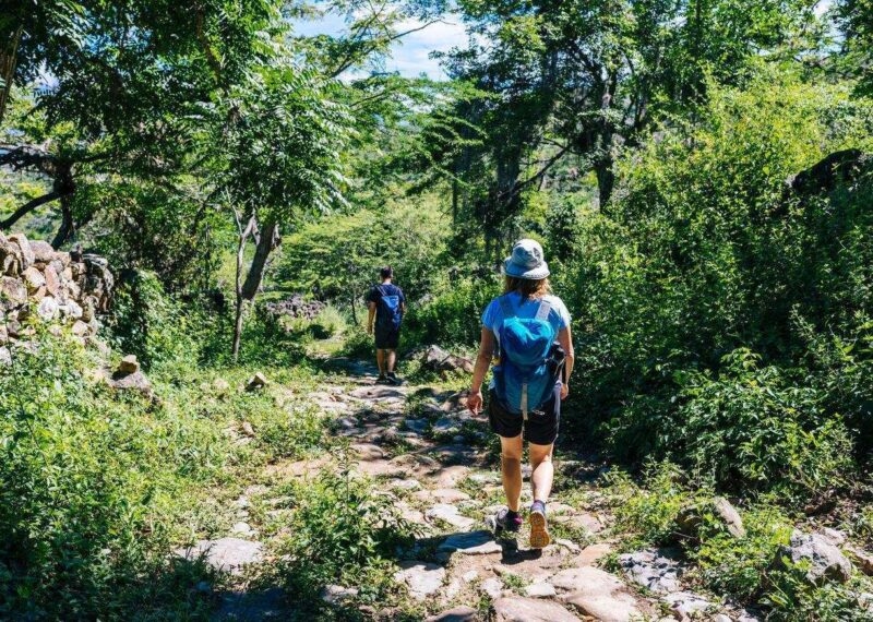 Two hikers on the ancient stone paved road from Barichara to Guane called "El Camino Real". , Barichara/ Colombia/ South America